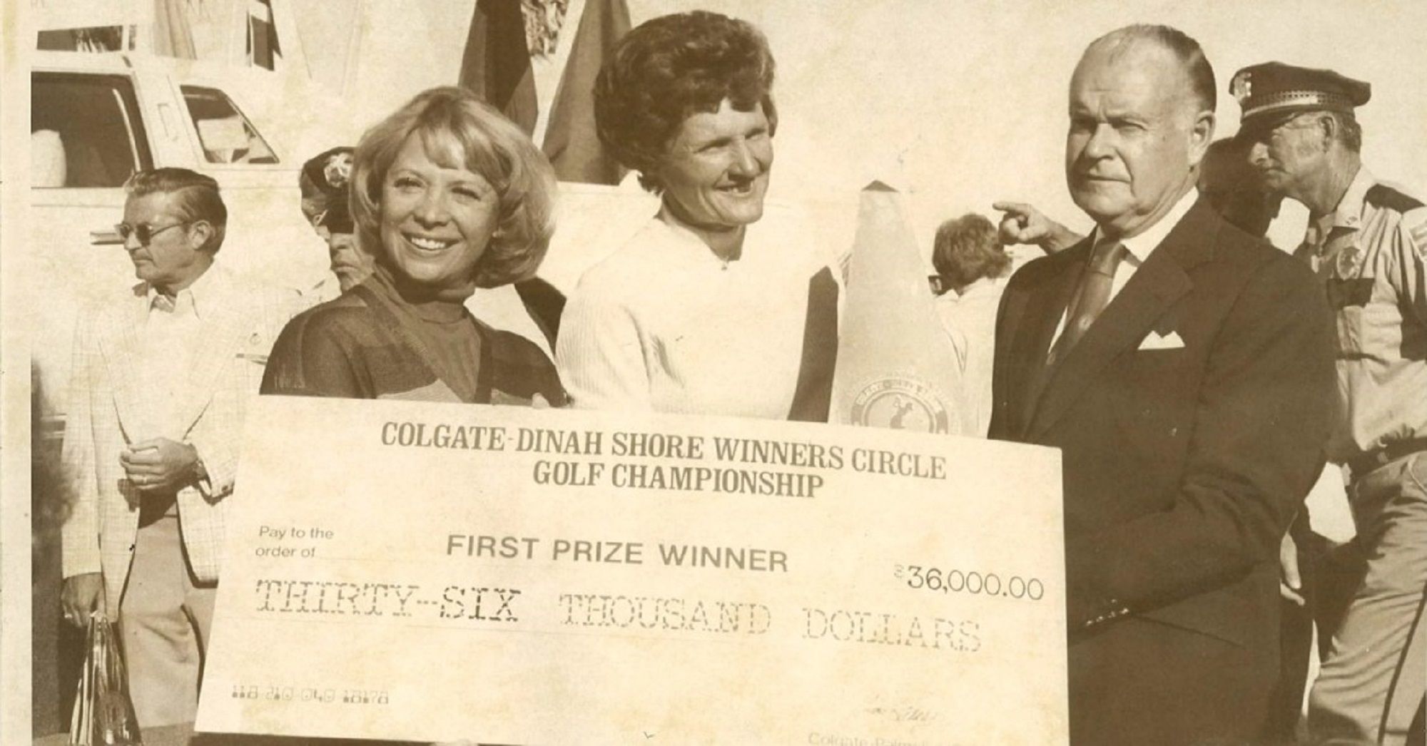 A picture of David Foster presenting the winners check at the Colgate Dinah Shore Winners Circle golf championship